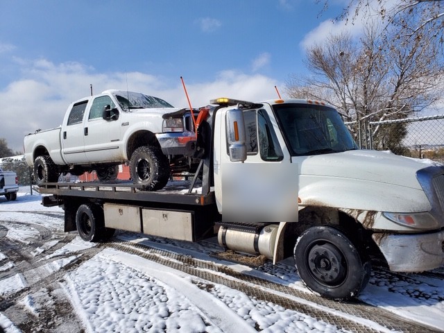 Tow truck operating in winter road conditions